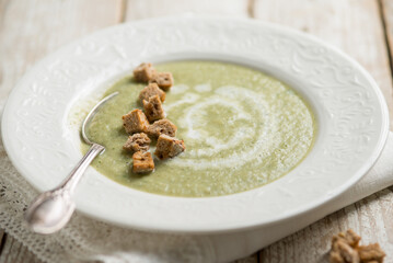 zucchinis soup with crusty bread and cream sauce