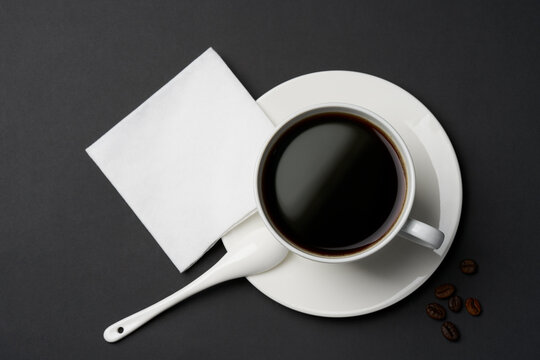 Black coffee and coffee beans on black background