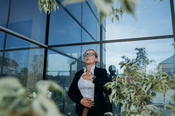 Businesswoman practicing breathing exercise on terrace
