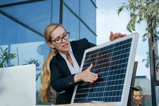 Businesswoman giving presentation about solar panel over video call on laptop