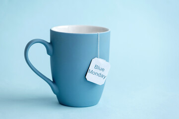 Blue Monday concept with blue cup on blue background