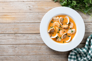 Seafood soup on wooden table. Top view. Copy space