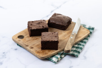 Chocolate brownie portions on marble background