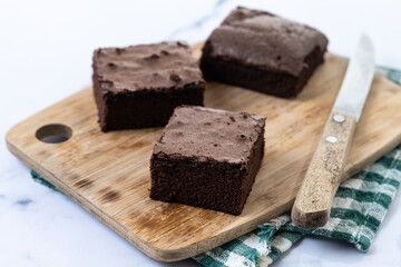 Chocolate brownie portions on marble background