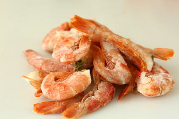frosted king prawns closeup photo on white table background © ulianna19970