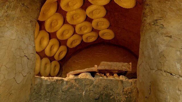 Bread from tandoor in Central Asia. Traditional Uzbek the pellets. Tandoor baked flat bread, flat cake or bread cake. National asian meal and food. 