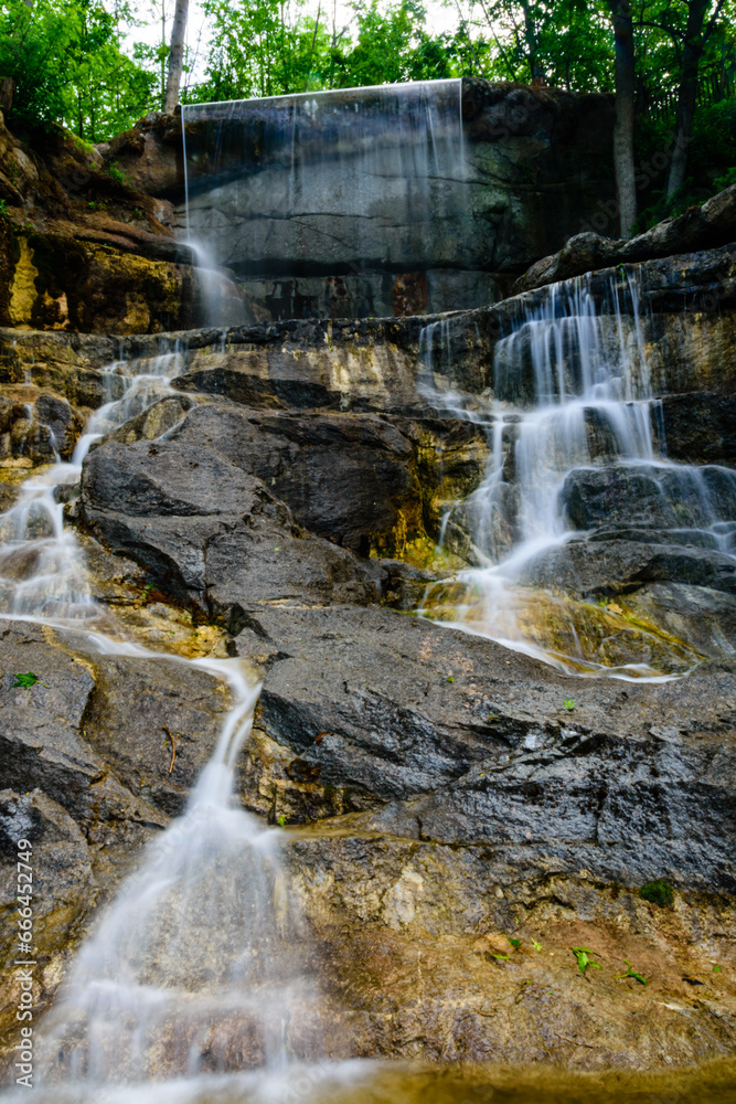 Wall mural beautiful waterfall on small river in a park