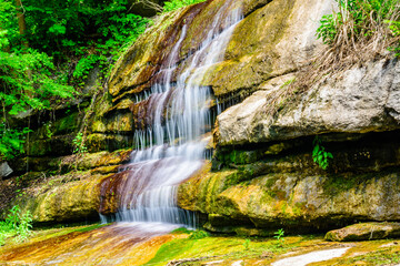 Fototapeta premium Beautiful waterfall on small river in a park