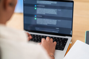 High angle soft focus of crop anonymous businesswoman using computer while working online on project from office in daylight