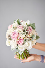 Bridal bouquet. The bride's . Beautiful of white flowers and greenery, decorated with silk ribbon.