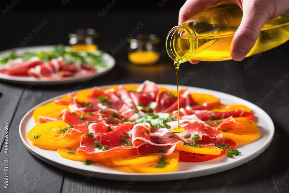 Sticker hand pouring oil over a plate of bell pepper carpaccio