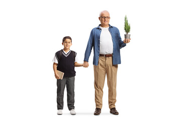 Full length portrait of a man with a small tree in a pot holding a schoolboy by the hand - Powered by Adobe