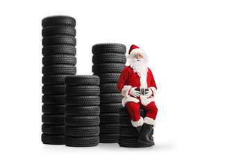 Santa claus sitting on a pile of car tires