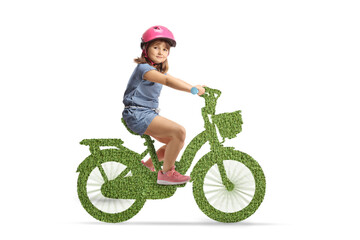 Girl riding a green eco bicycle with a helmet and looking at camera