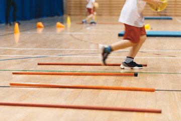 Futsal training field. Indoor football practice for children. Indoor soccer training during the winter. Futsal training field with orange poles yellow cones and red hurdles. Physical education 