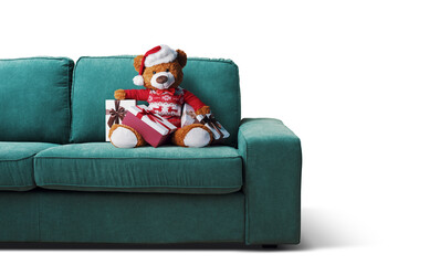 Cute teddy bear with Santa hat on the couch