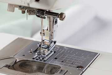 Sewing machine, stitching fabrics, needle in a round plan