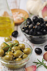 Black and green olives in glass bowls