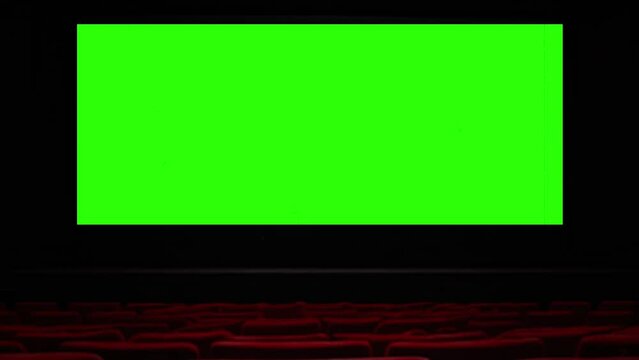 Movie Theater Green Screen Projection Film Texture Zoom In Empty Cinema Seats. Green screen projection, for replacement, on an empty movie theater, zoom in. Empty seats