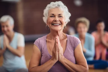 Keuken spatwand met foto Portrait of a happy senior woman taking park in a yoga or fitness class © ink drop
