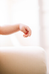 detail of the hand of a newborn in studio lighting against white