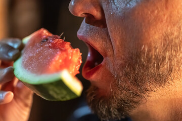 Senior man ready to bite into a watermelon.