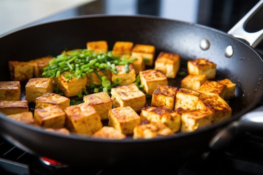 detailed shot of tofu browning in a pan