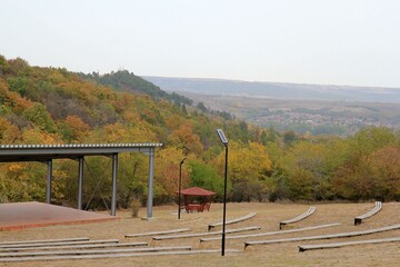 Wooden gazebo on the background of a picturesque autumn forest in the vicinity of Beloslav in...