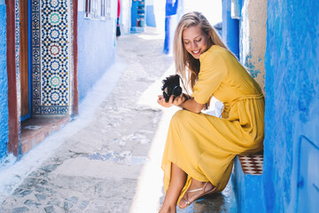 Delighted female photographer in aged town