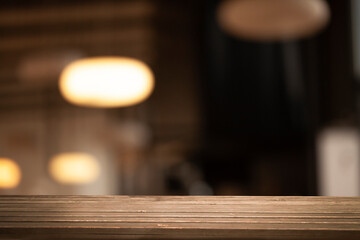 empty table to showcase your product on blurred golden bokeh cafe background. window bokeh