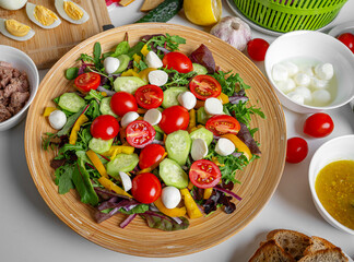 Vegetable salad with mozzarella and lettuce. Other ingredients are visible.