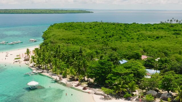 Tropical beach with palm trees. Virgin Island, Philippines.