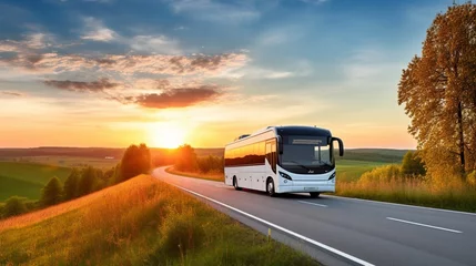 Foto op Canvas White bus traveling on the asphalt road around line of trees in rural landscape at sunset.  © Abbassi