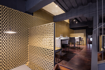 A white table sitting in a room restaurant with gold walls