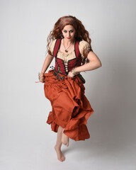 Full length portrait of beautiful red haired woman wearing a medieval maiden, fortune teller...