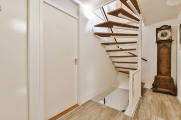 Hallway with spiral staircase and grandfather clock