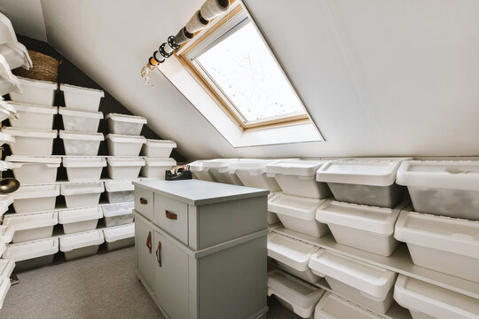 Cabinet and plastic boxes arranged in attic room
