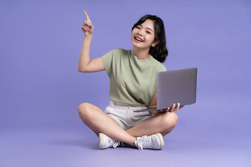 Portrait of beautiful asian woman posing on purple background