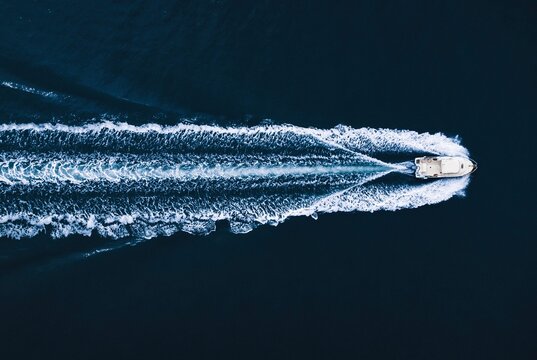 Motorboat floating in dark ocean