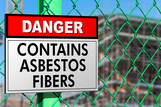 Dangerous presence of asbestos fibers in a construction site with metallic protection net against the intrusion of unauthorized persons and warning signboard