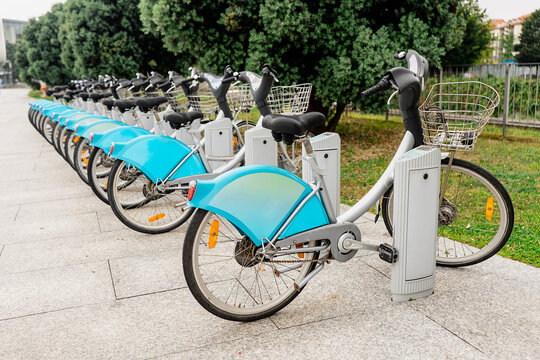 Blue city rental bicycles lined up at docking station