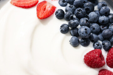 Greek yogurt with blueberries and strawberries, close up
