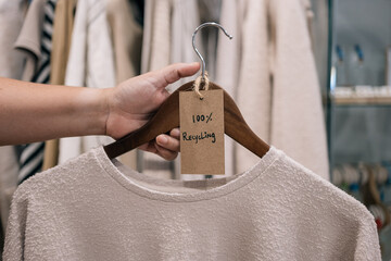 Sweater in boutique labeled as 100% recycled material.