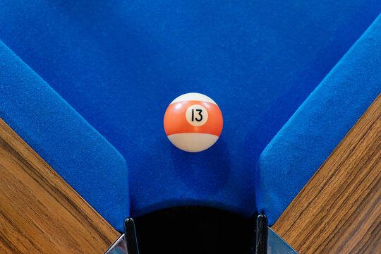 Billiard ball on blue pool table