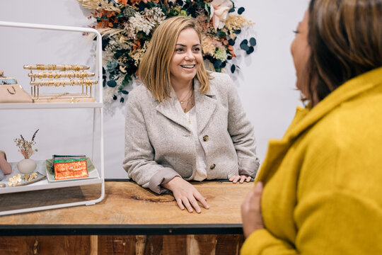 Engaging store owner chatting with a client at her boutique.