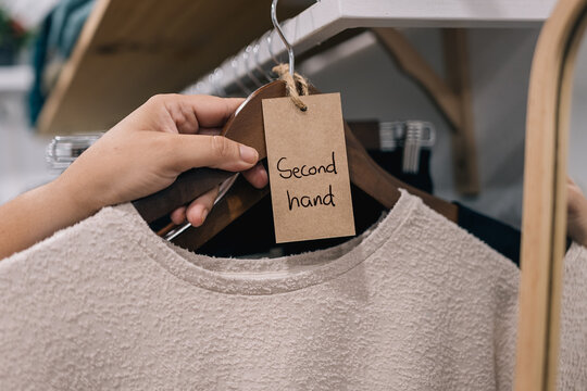 Sweater labeled as "Second hand" in a boutique setting.