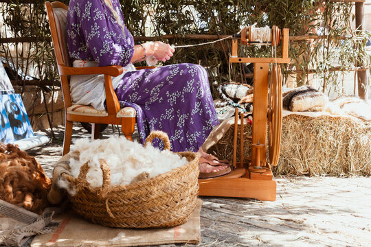 anonymous Woman spinning wool by a traditional wheel