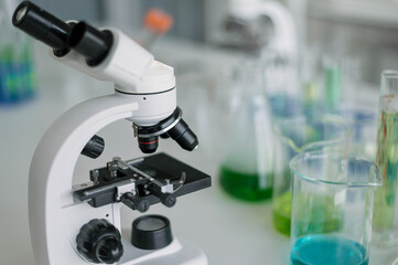 Microscope with glassware beaker. Science chemistry laboratory research and development concept.