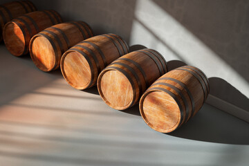 Wine, whiskey, or brandy wooden barrels storage. Rays of sunlight in a cellar
