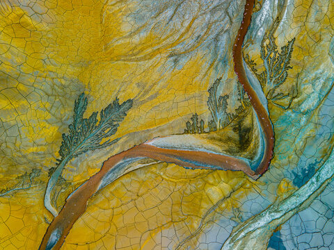 A river running through a yellow field